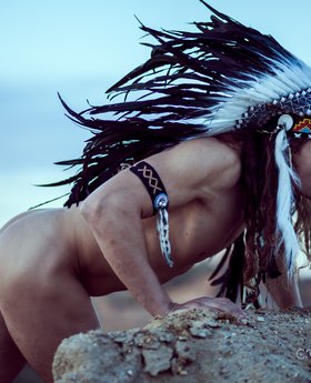 Stunning naked red Indian man alone outdoors