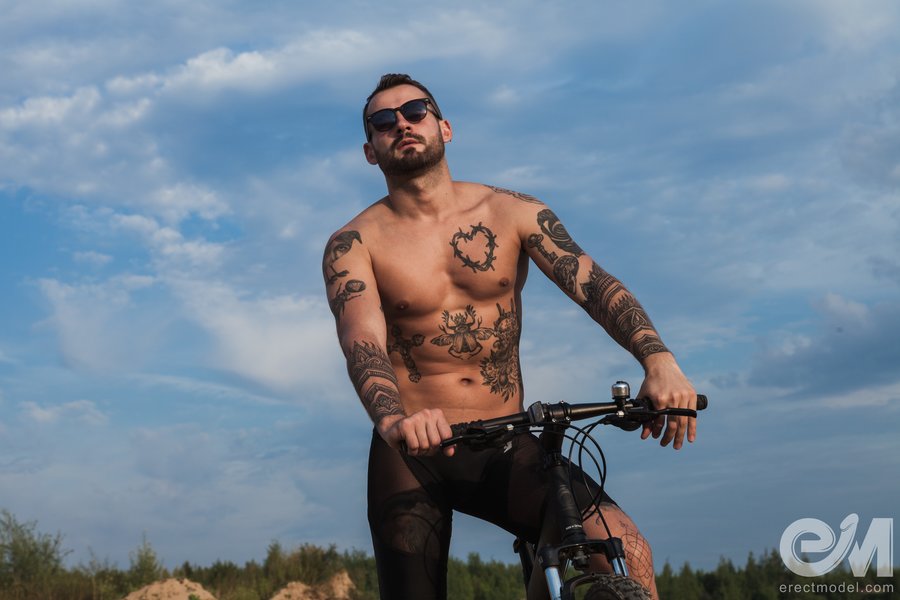 Fully tattooed man poses in see through cycling shorts