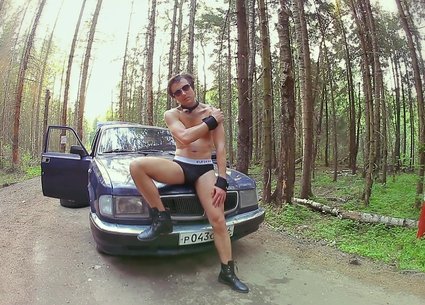 Hot naked man on the hood of the old russian car