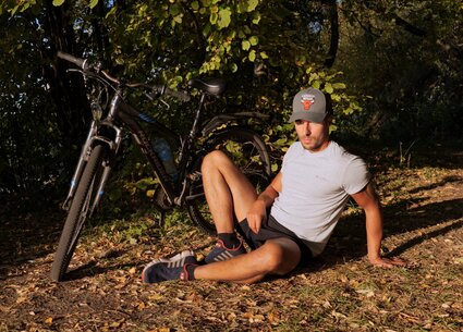 Cyclist jerking in public place meeting the beautiful sunset