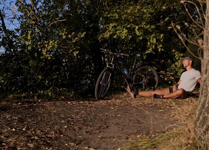 Cyclist jerking in public place meeting the beautiful sunset