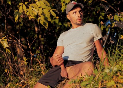 Cyclist jerking in public place meeting the beautiful sunset