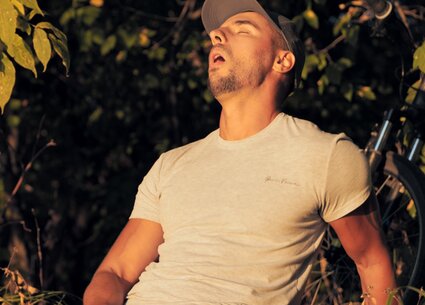 Cyclist jerking in public place meeting the beautiful sunset