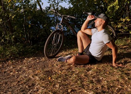 Cyclist jerking in public place meeting the beautiful sunset