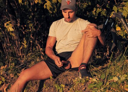 Cyclist jerking in public place meeting the beautiful sunset