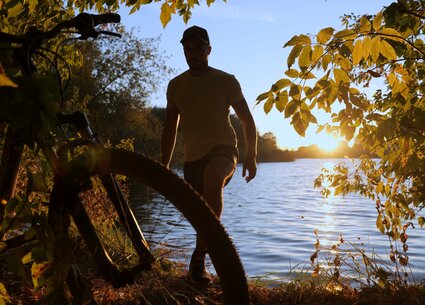 Cyclist jerking in public place meeting the beautiful sunset