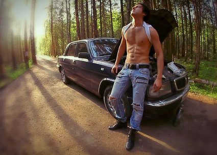 Hot guy in jeans repairing car and undressing