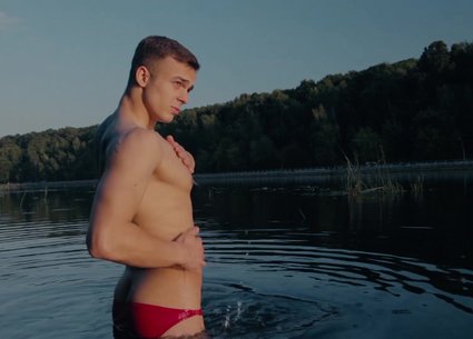 Cute teen boy stripping until naked in the river