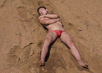 Kinky man covered in sand and his dirty penis and anus