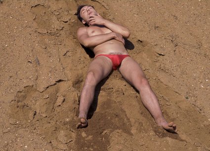 Kinky man covered in sand and his dirty penis and anus